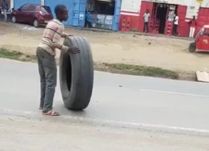 اقدام خطرناک و عجیب نوجوان آفریقایی با حرکت روی لاستیک کامیون / فیلم